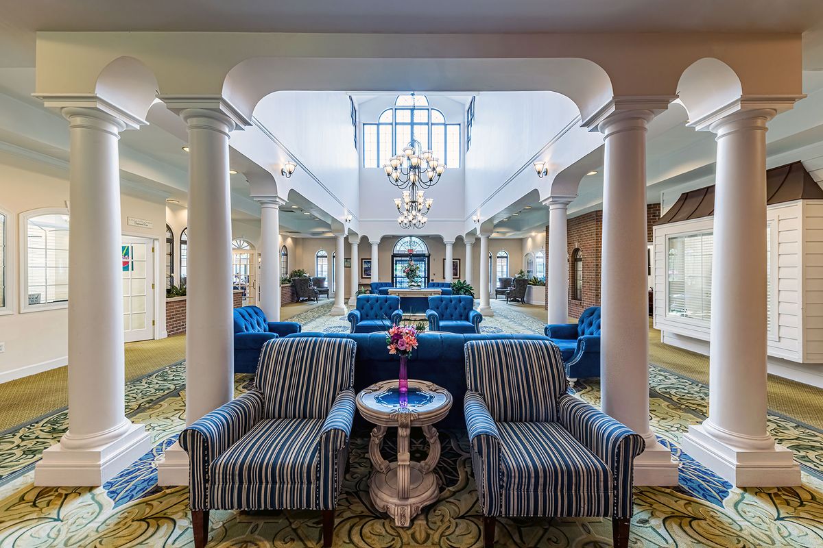 Spacious hotel lobby with elegant furnishings and decor.