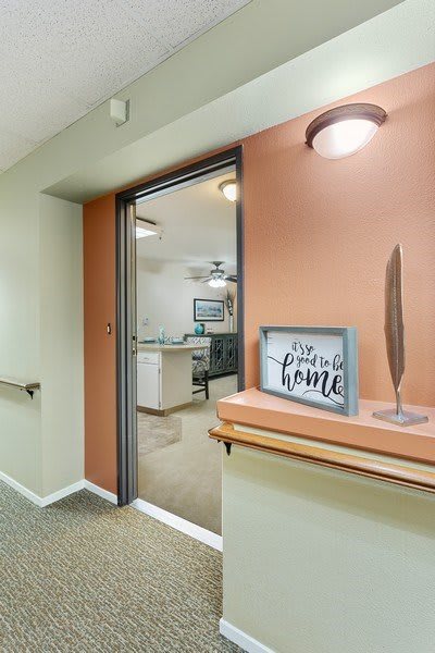 A modern hallway entrance with a decorative sign that reads 'the perfect home'.