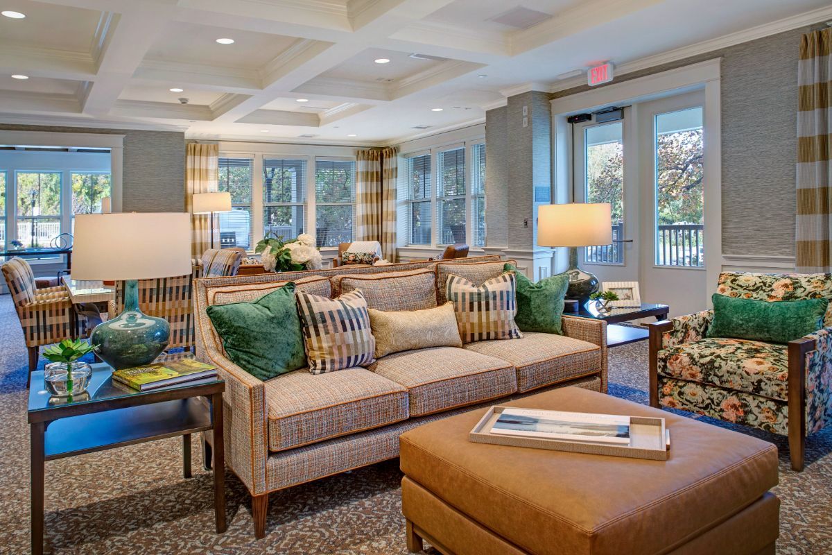 A cozy and modern living room with a neutral color scheme, featuring comfortable sofas and ample natural light.
