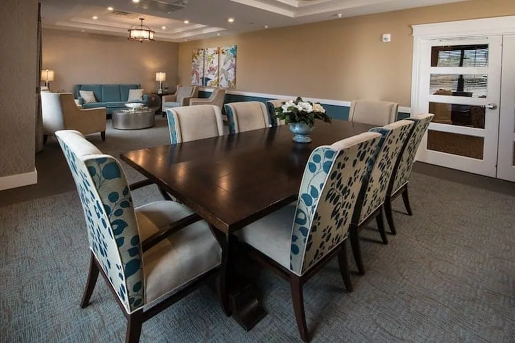 A well-decorated dining area with a dark wooden table and upholstered chairs.