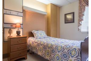 A cozy bedroom with a single bed and nightstand.