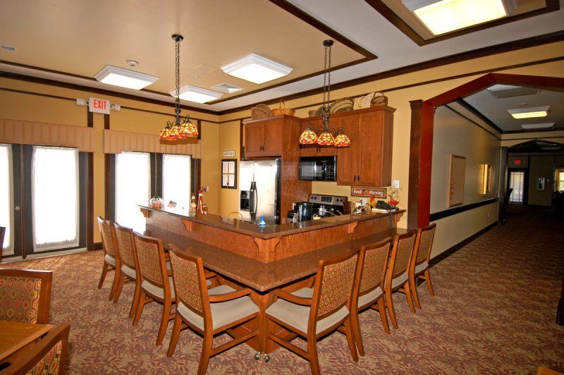 A cozy kitchen bar area with wooden furniture and pendant lighting.