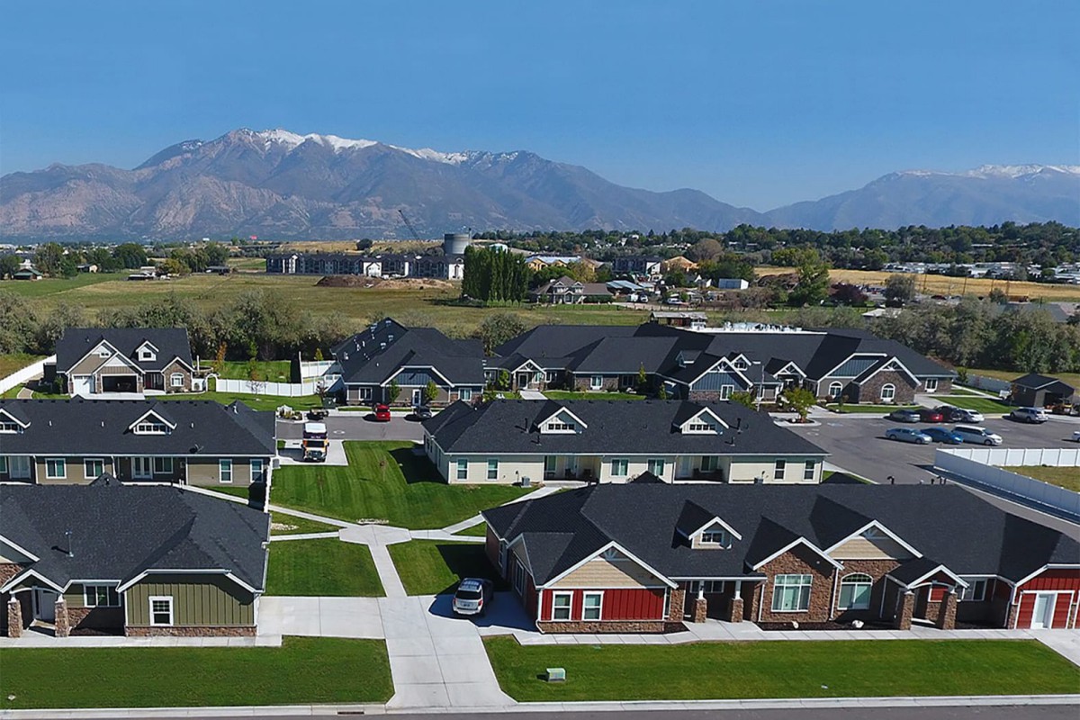 Aerial view of a suburban neighborhood with mountains in the background.