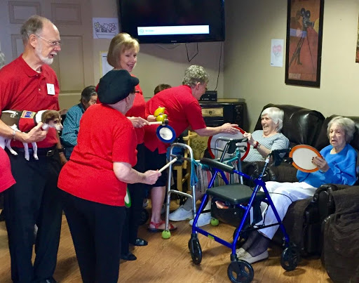Volunteers engaging with residents in a warm, supportive environment.