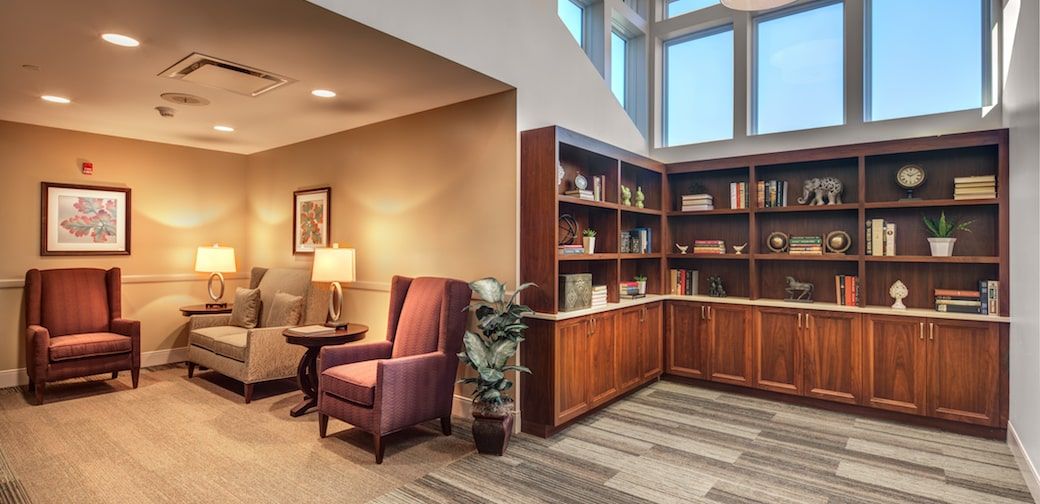A cozy library corner with a comfortable reading chair and well-organized bookshelves.
