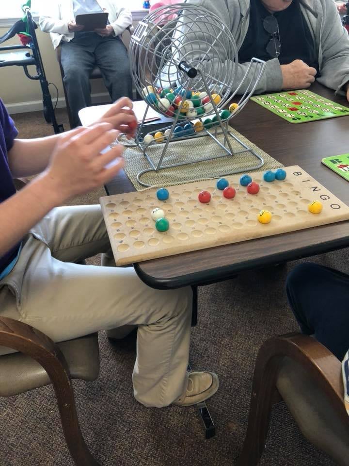 People playing bingo indoors at a table.