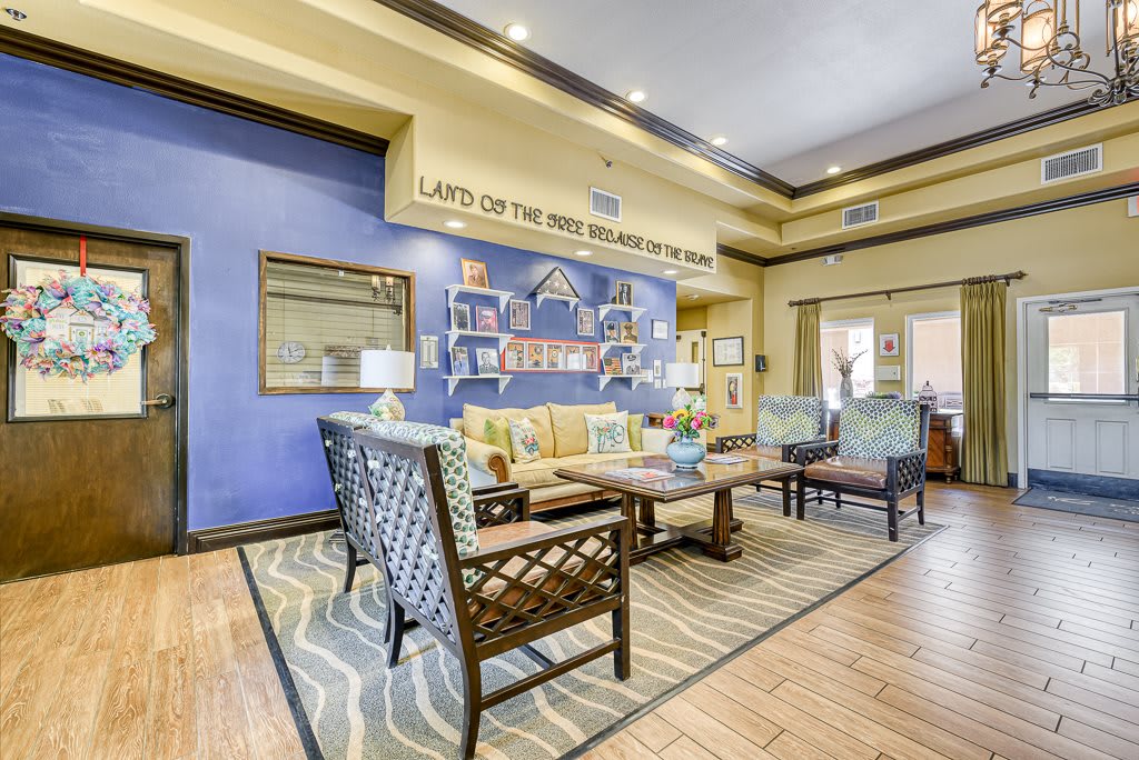 A stylishly decorated living room with a blue accent wall and comfortable seating.