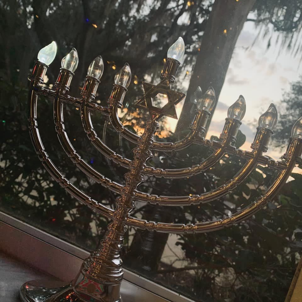 A menorah with lit bulbs on display during Hanukkah.