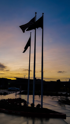 A beautiful sunset with flags silhouetted against the colorful sky.