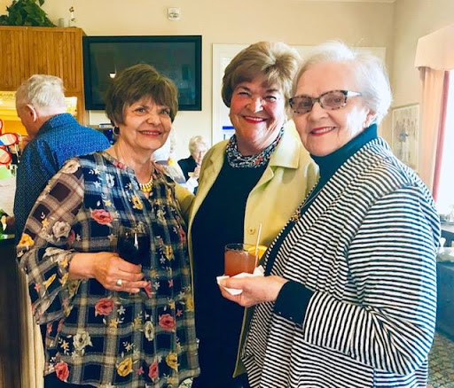 A joyful gathering of friends sharing smiles and drinks.