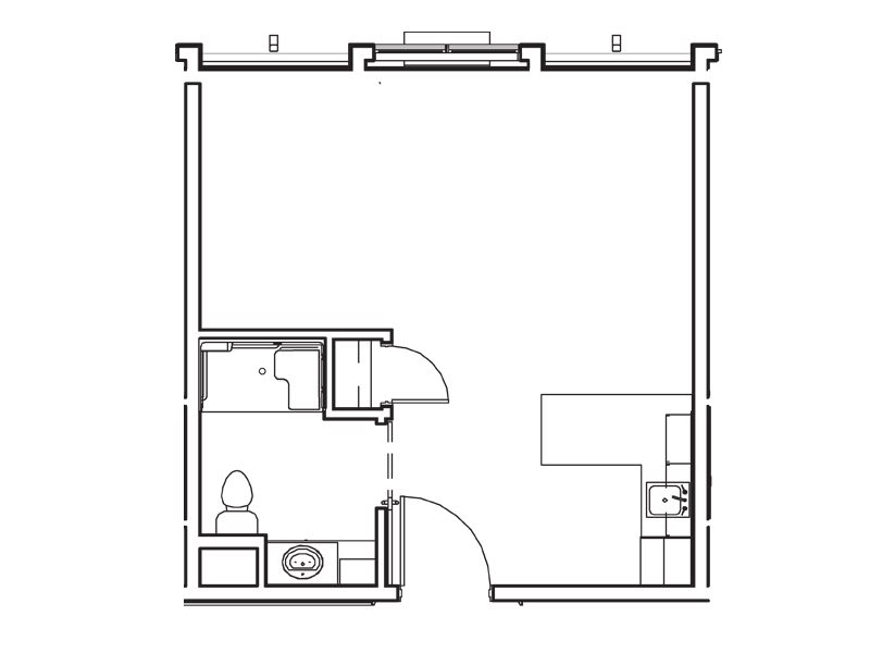 A simple apartment floor plan showing a bathroom, kitchen area, and a large central living space.