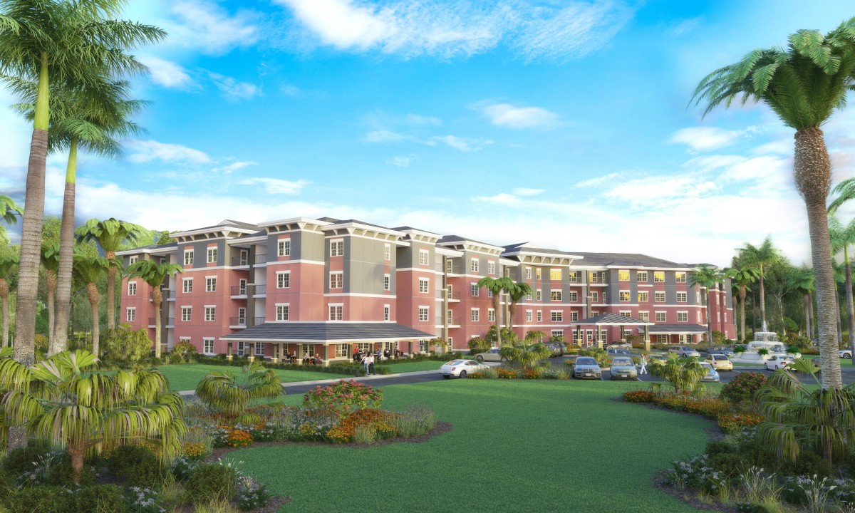 A modern residential apartment complex with landscaped surroundings under a clear blue sky.