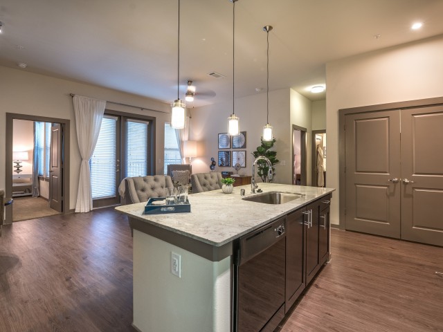 A modern open-concept kitchen with an island and pendant lighting.