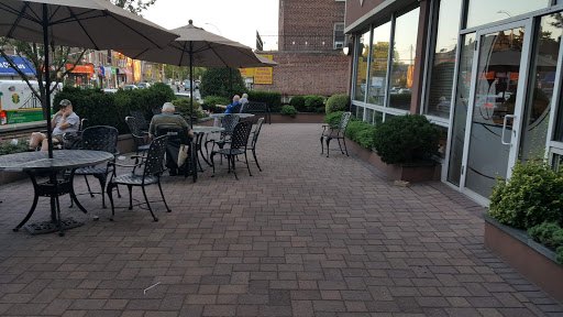 A cozy outdoor dining area with tables and umbrellas, perfect for an evening meal.