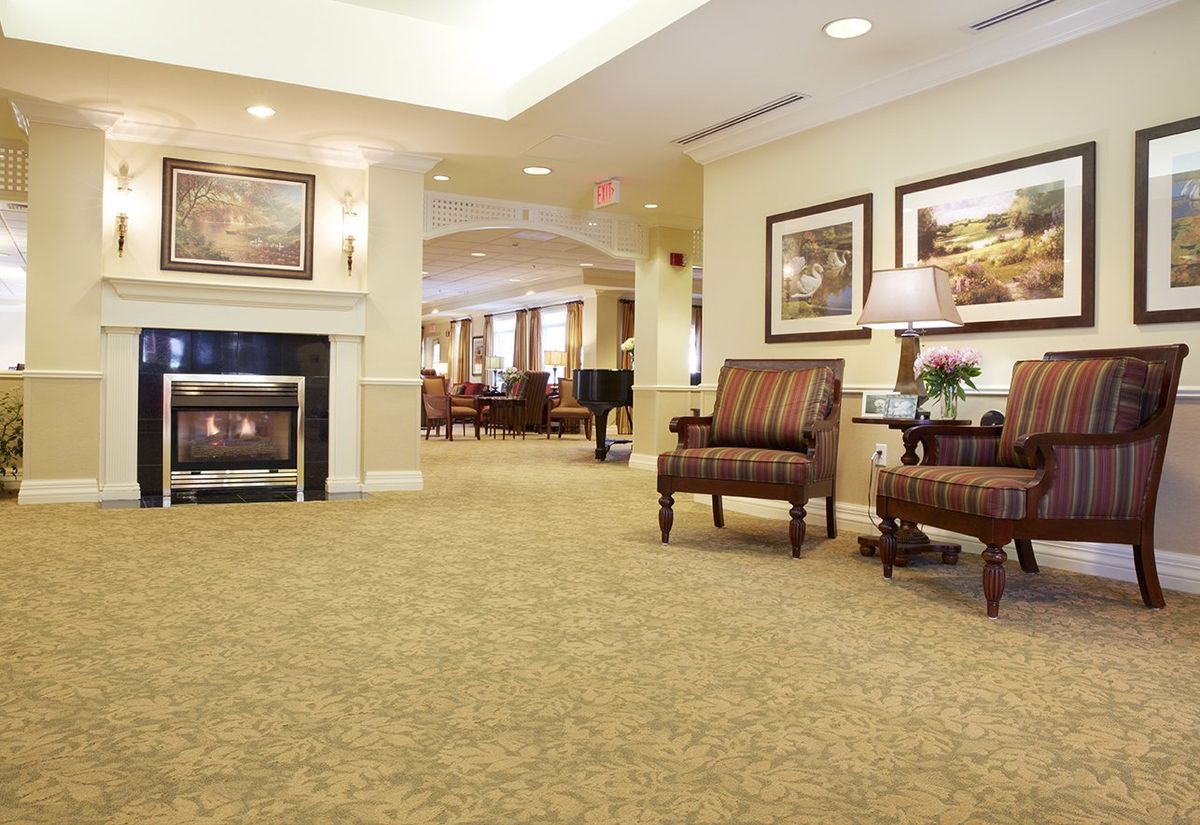 A cozy lobby with comfortable seating and a fireplace.