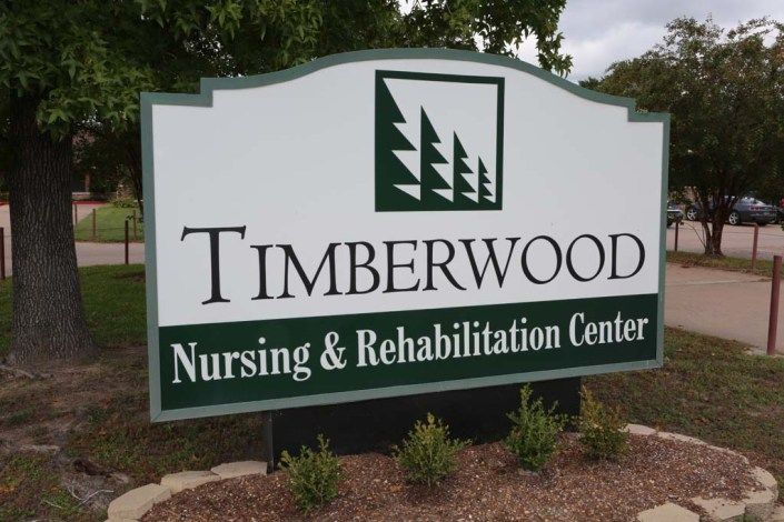 Sign for Timberwood Nursing & Rehabilitation Center.