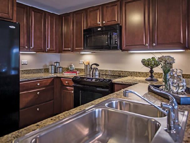 A modern kitchen with wooden cabinets and stainless steel appliances.