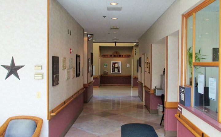 A view down an empty hallway leading to a reception area.