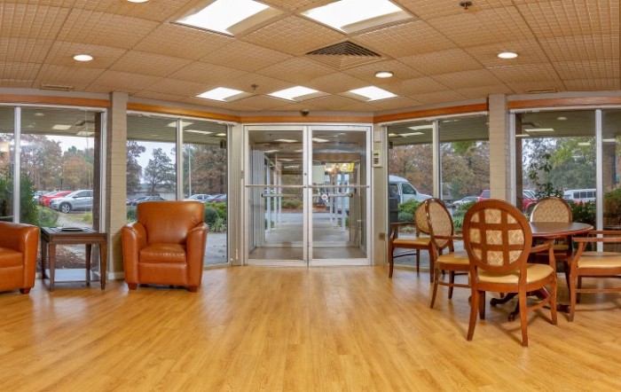 A spacious lobby area with comfortable seating and a glass entrance.
