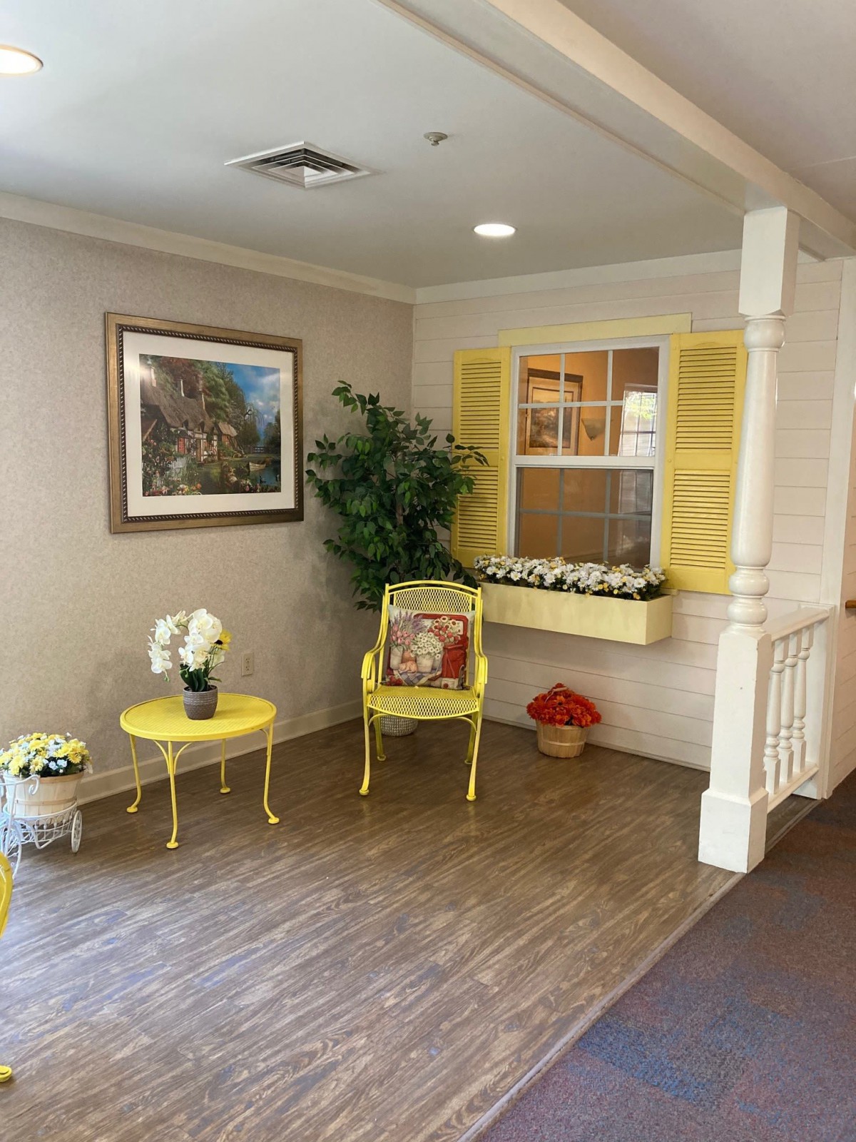 A cozy indoor space with yellow furniture and decorative plants.