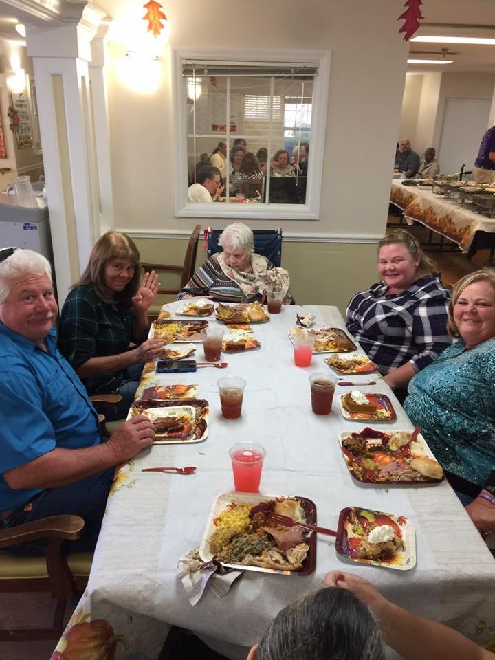 A family enjoying a meal together at a dinner table.
