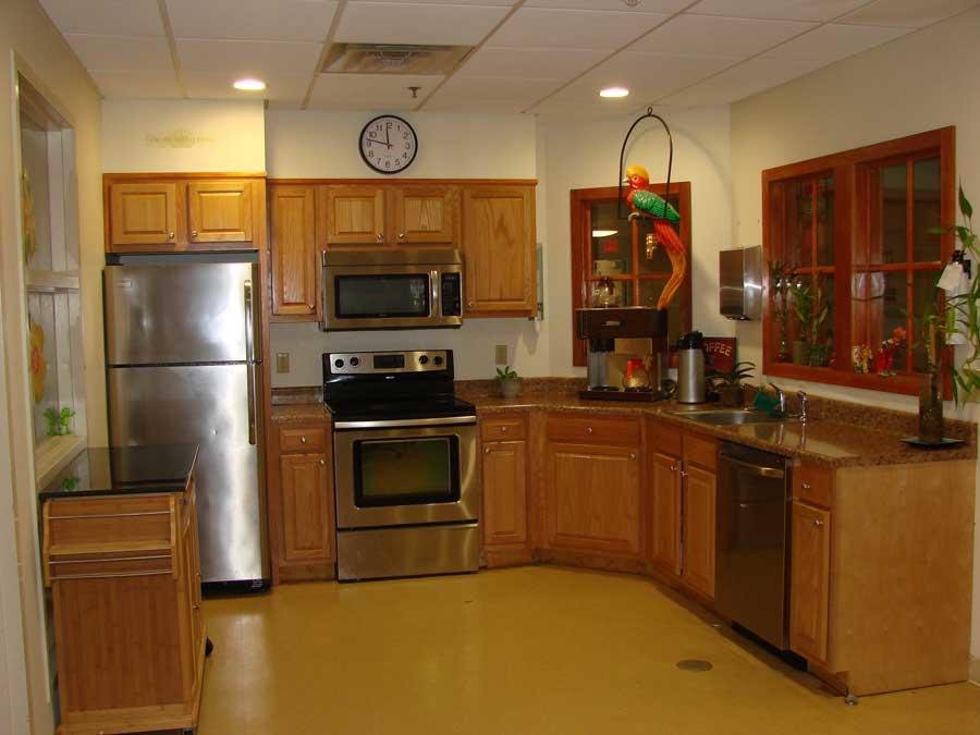 A modern kitchen with stainless steel appliances and wooden cabinets.