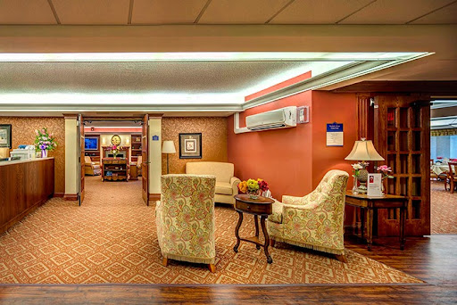 A cozy lobby area featuring comfortable seating and warm interior design.