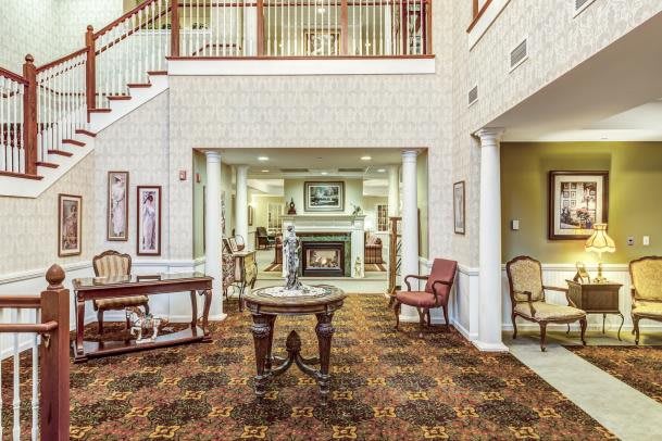 Elegant lobby area with seating and a fireplace.