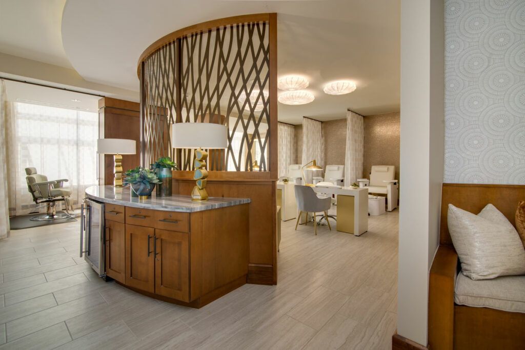 A modern office space with elegant wood paneling and a decorative partition, featuring contemporary furniture.