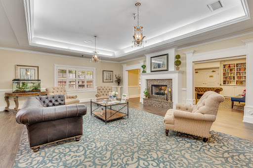 A beautifully designed living room featuring comfortable seating, a decorative fireplace, and an inviting ambiance.