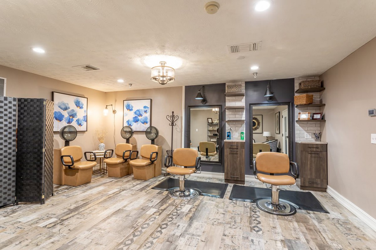 A modern hair salon interior with styling chairs and mirrors.