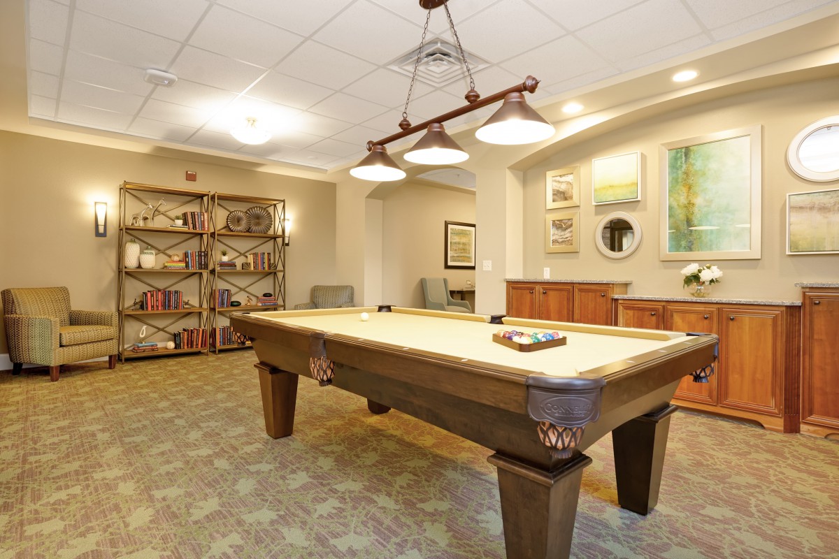 A cozy game room featuring a billiards table and stylish decor.