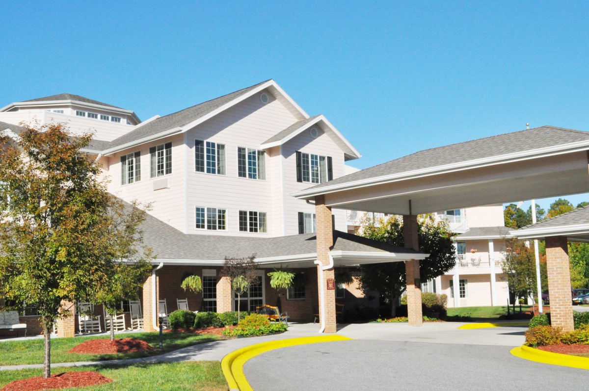 A residential building with a landscaped entrance, likely part of a retirement or senior living community.