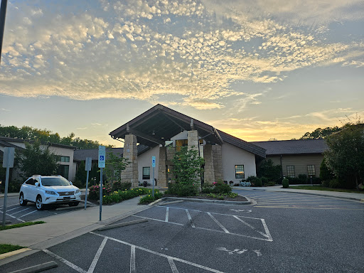 A tranquil view of a building against a stunning sunset sky.