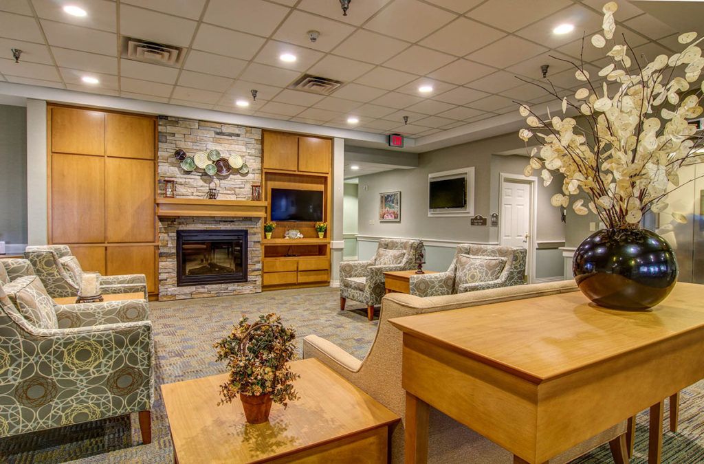 A cozy lobby with comfortable seating and a fireplace.