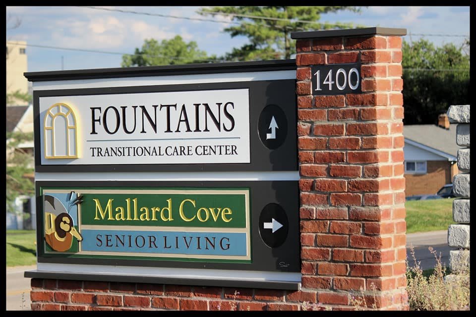A sign for Fountains Transitional Care Center and Mallard Cove Senior Living at address 1400.