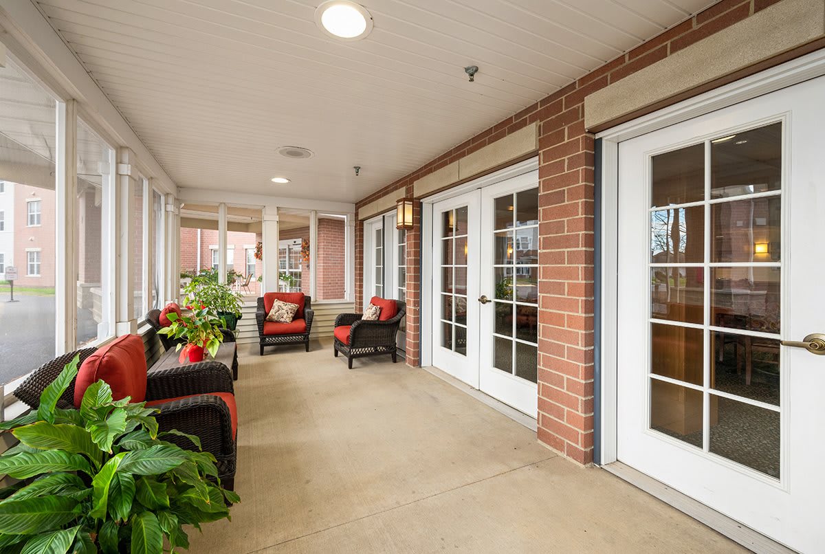 A cozy indoor patio with comfortable seating and greenery.