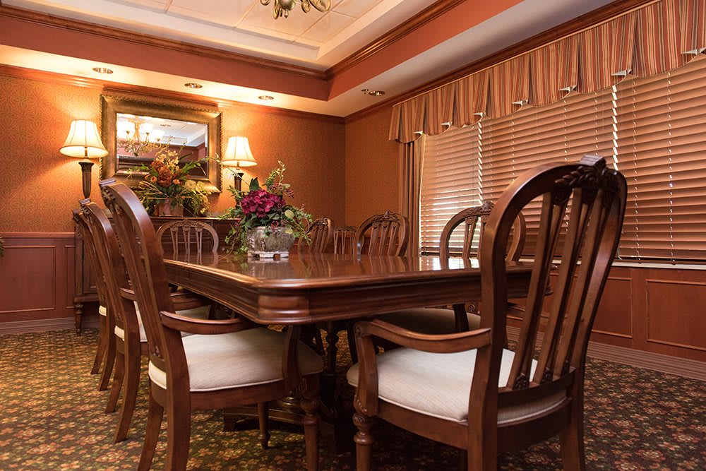 A traditional dining room with wooden furniture and elegant decor.