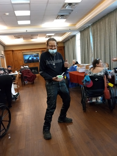 A lively atmosphere as a person engages in a fun dance amidst others enjoying their time.