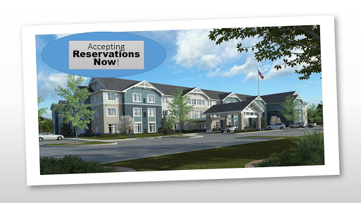 A modern hotel exterior with a sign indicating that reservations are being accepted.