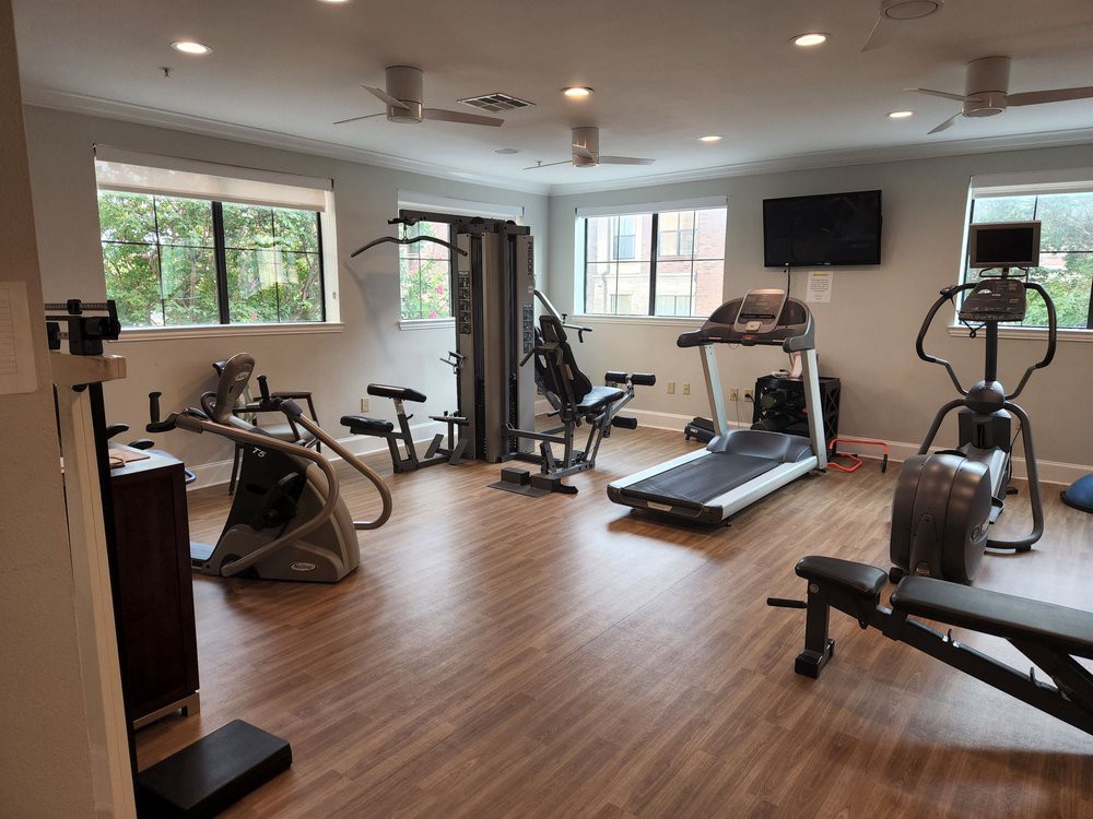 A well-equipped gym with various fitness machines and exercise equipment.