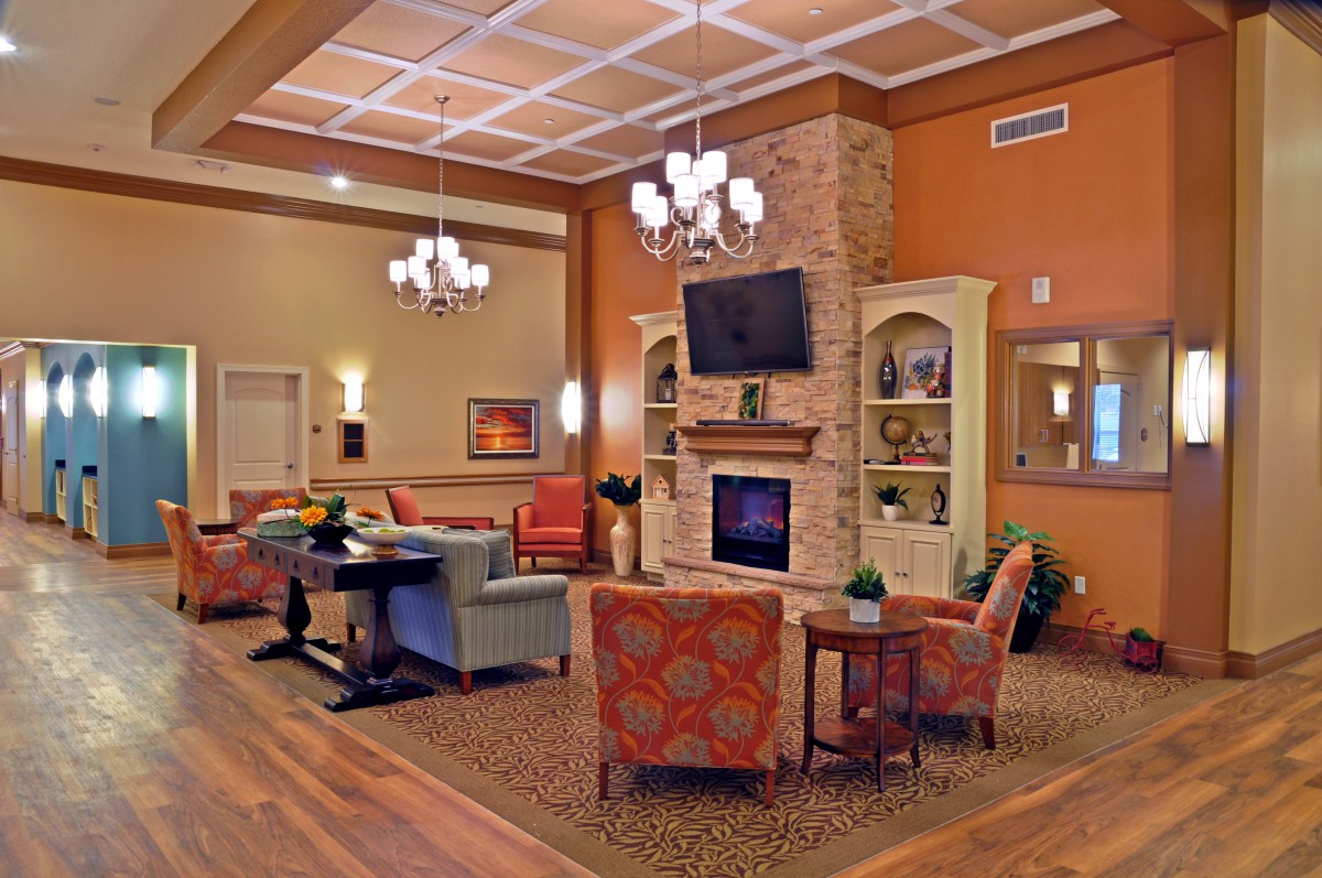 A cozy living room with a fireplace, television, and comfortable seating area.