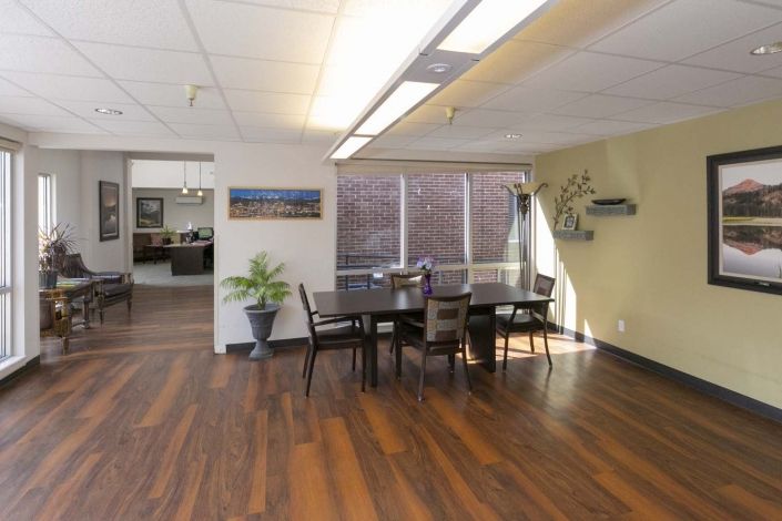 A well-lit conference room featuring a large table, chairs, and decorative elements.
