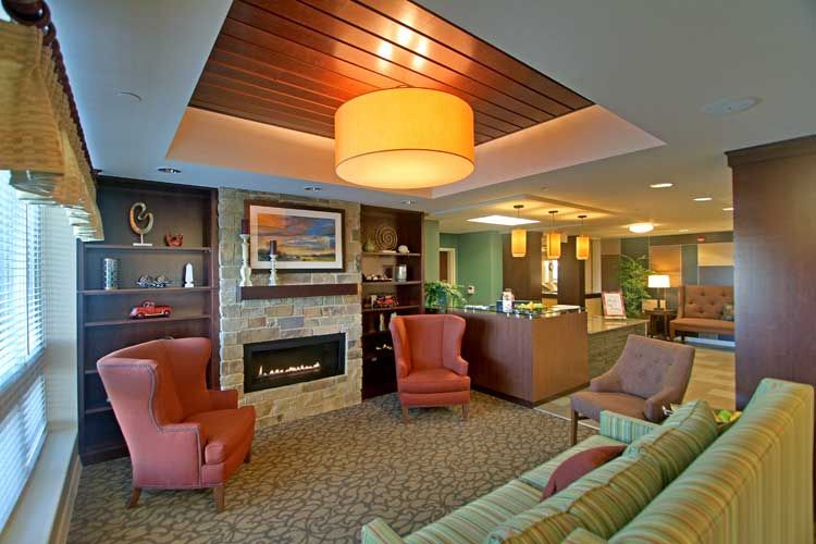 A cozy living room featuring a fireplace, comfortable seating, and warm lighting.
