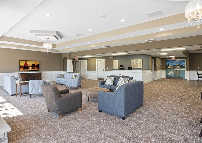 A spacious, modern lobby with comfortable seating and a reception desk.