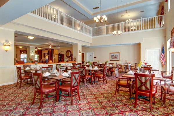 A spacious dining room with elegant furnishings and ambient lighting.