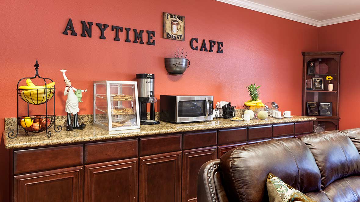 A cozy cafe interior featuring a snack counter with appliances and decor.