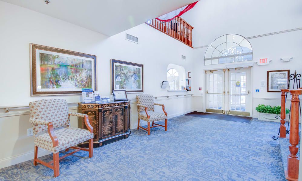 A spacious and bright lobby area with comfortable seating and decorative artwork.