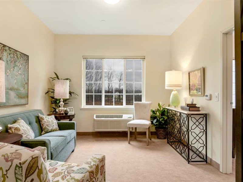 A cozy living room with comfortable seating, elegant lighting, and decorative accents.