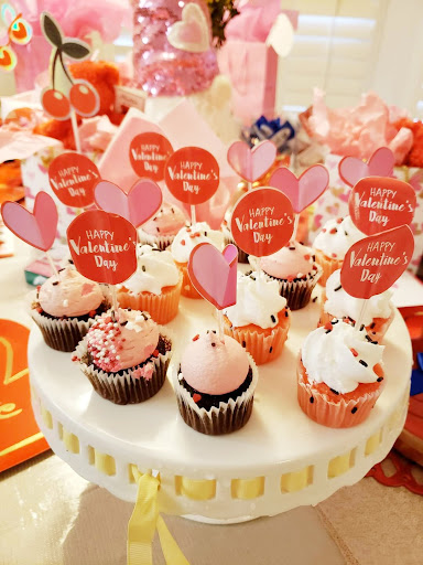 A delightful array of Valentine's Day cupcakes adorned with festive decorations, perfect for a sweet celebration.